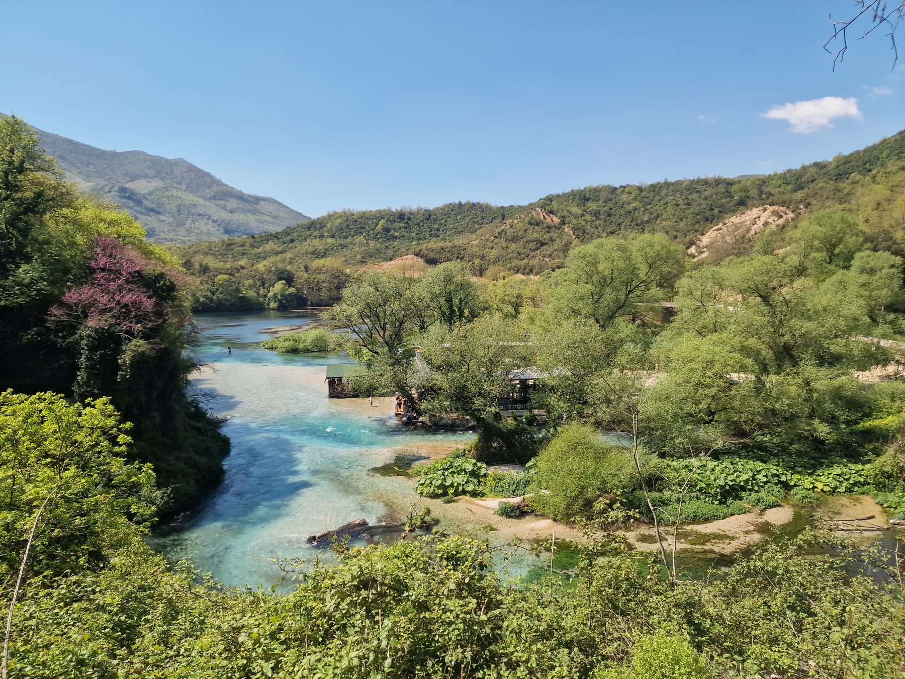 A turquoise river winding through the valley