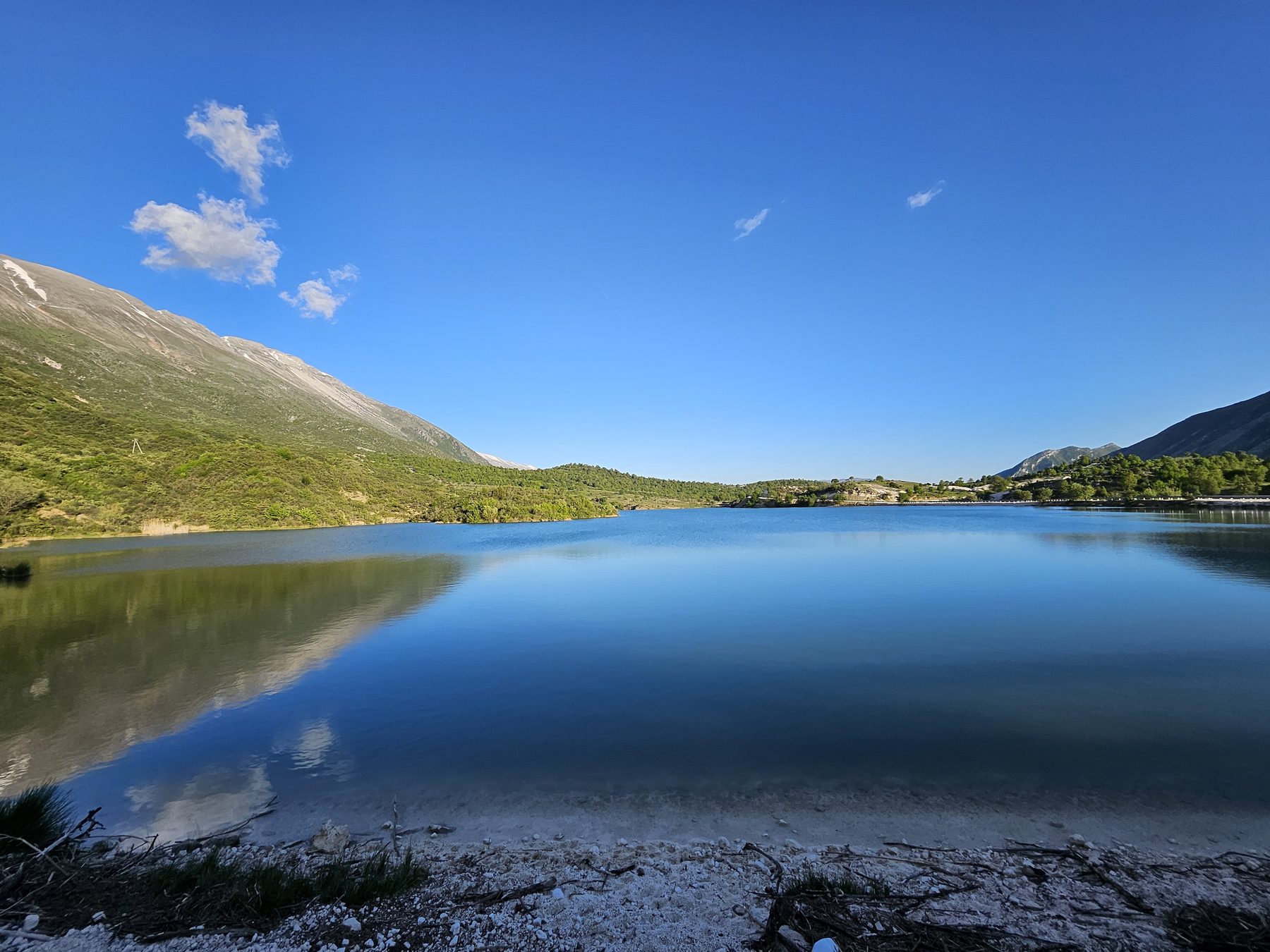 A still mountain lake reflecting the sky